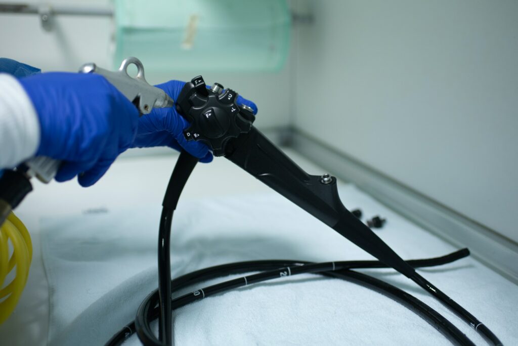 Nurse doctor preparing equipment for endoscopy inside emergency hospital room - Focus on tube set